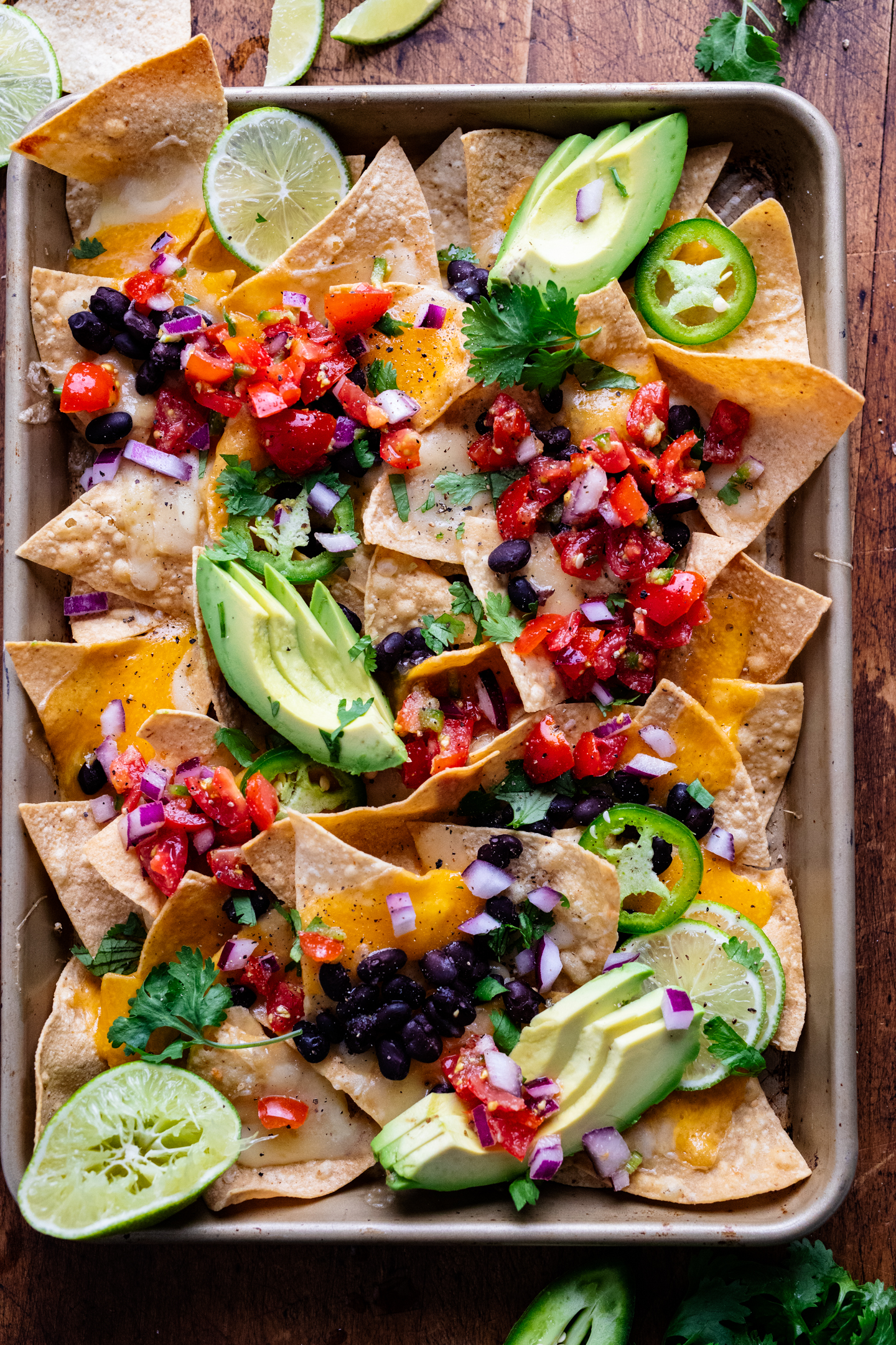 loaded vegetarian sheet pan nachos on a baking sheet.