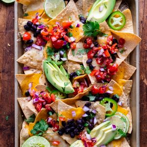 loaded vegetarian sheet pan nachos from a birds eye view on a baking pan