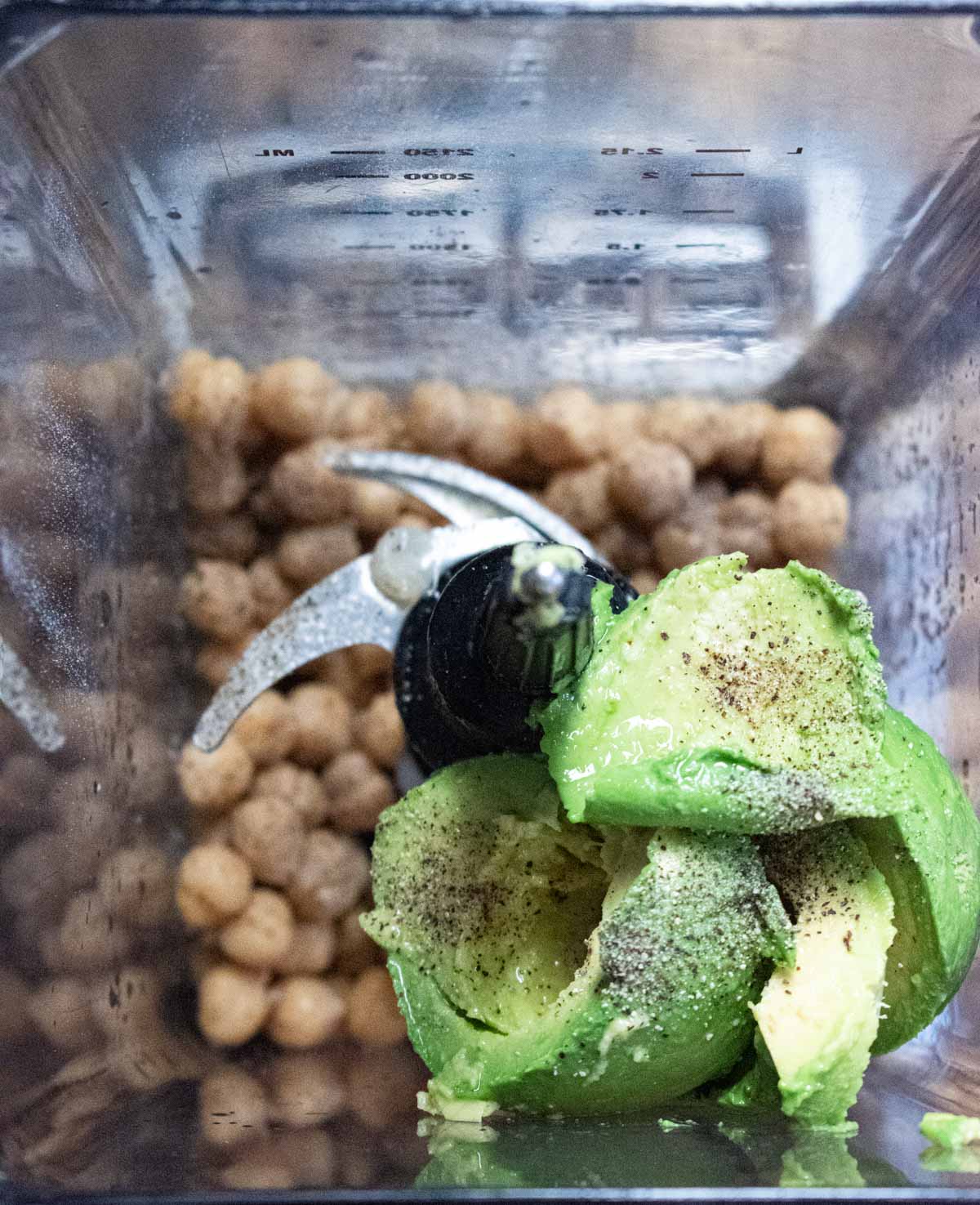 ingredients needed for avocado hummus placed inside of a blender