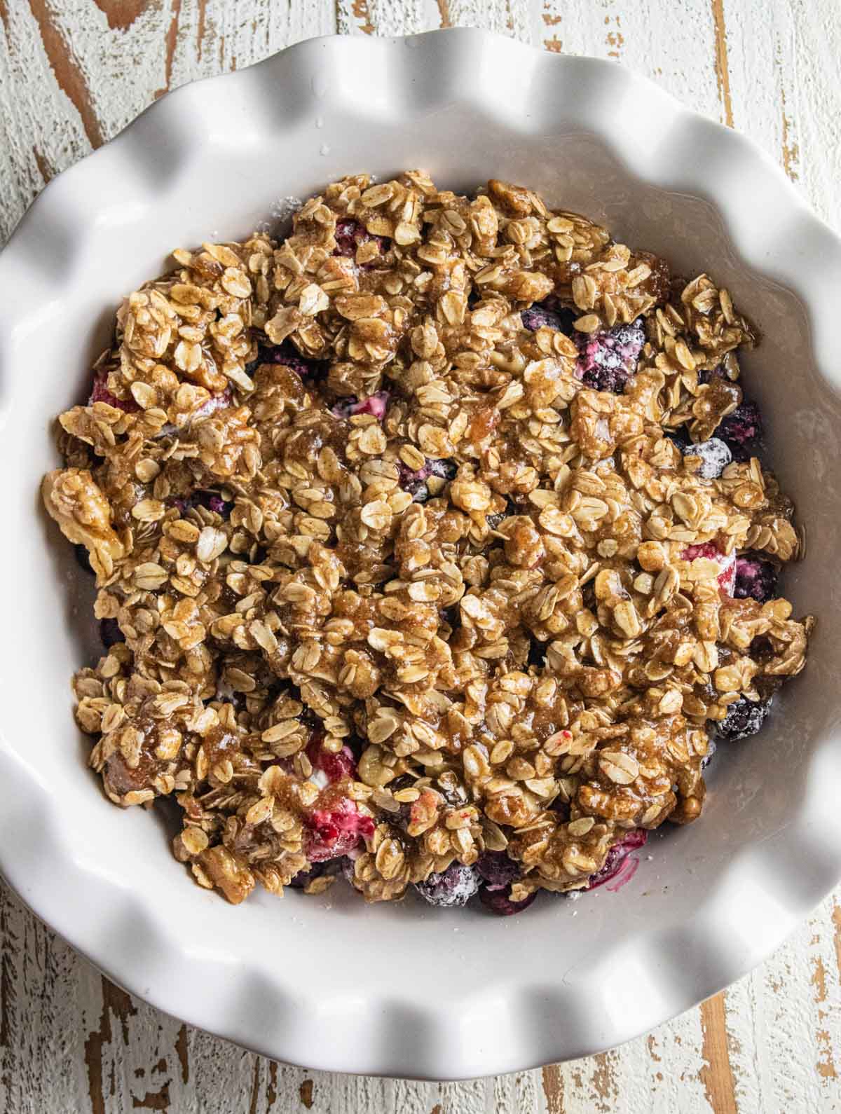 Fruit Crisp topped with homemade crumbled topping right before being baked in the oven. 