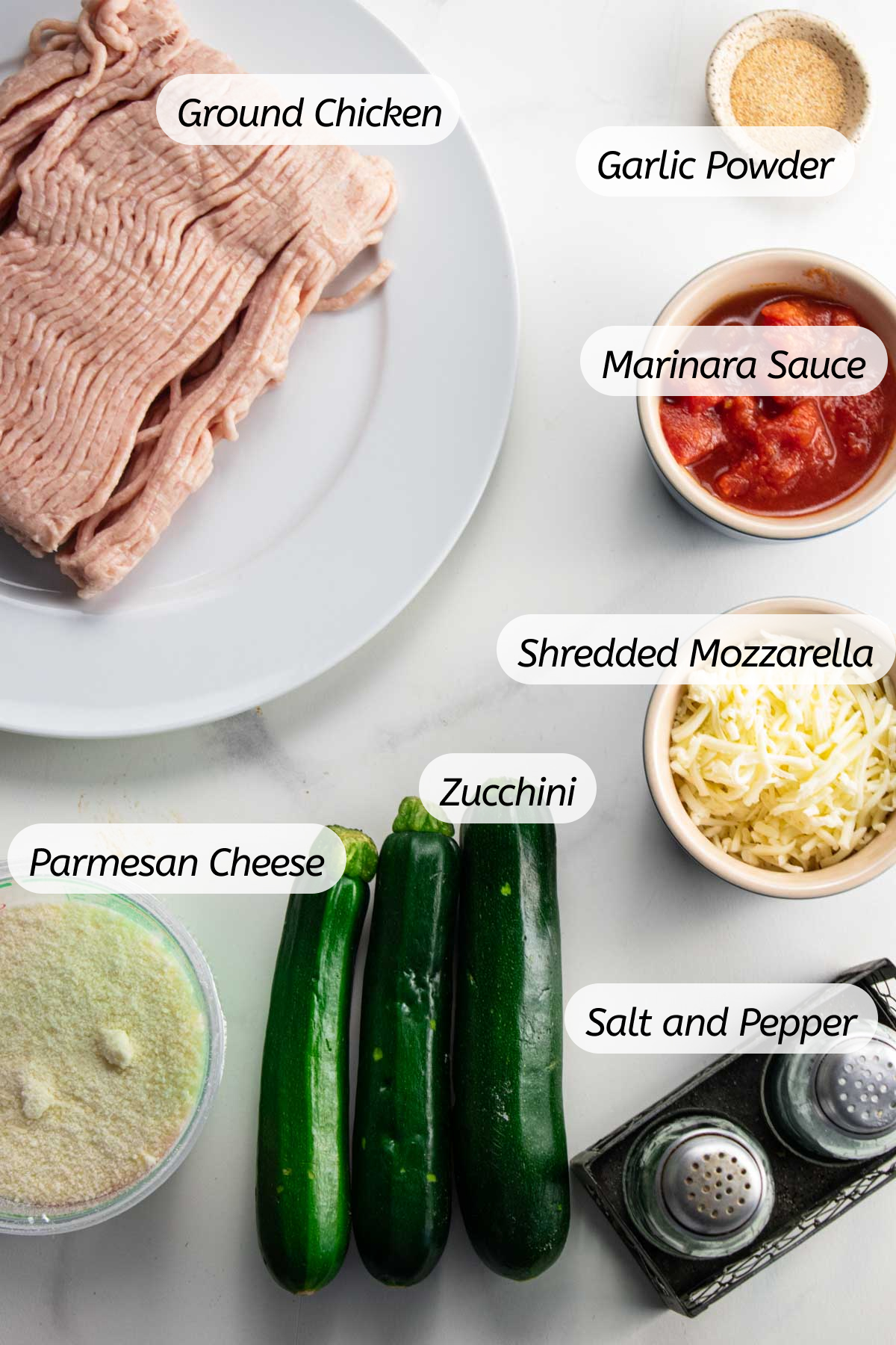 a birds-eye view of all the ingredients with labels included that you will need to make these stuffed zucchini boats 