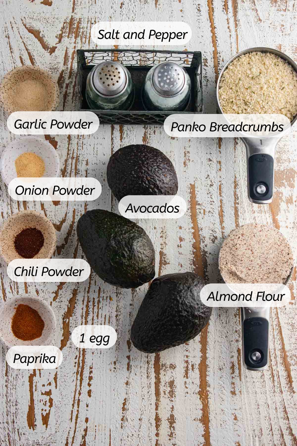 A birds-eye view of all the ingredients you will need for air fryer avocado fries with labels included.