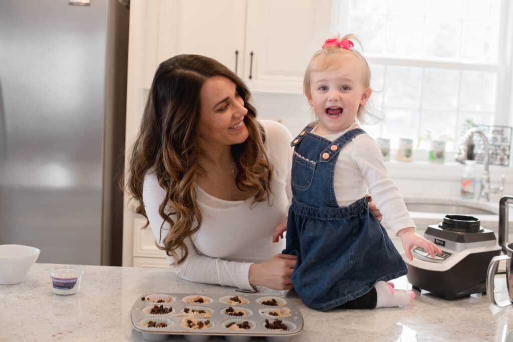 The author of the recipe with a little blonde girl making muffins.